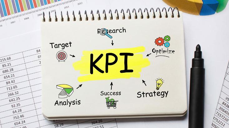 A hand-drawn notebook page with a sketch of a compass in the center, surrounded by various elements like a magnifying glass, gears, pie chart, trophy, light bulb, and gears. The compass represents the direction and guidance provided by KPIs in business intelligence, while the surrounding elements symbolize the various stages of planning and strategizing.